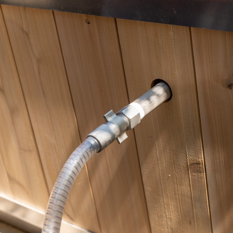 A man installing the Leisurecraft Canadian Timber Polar Cold Plunge Tub, showing how easily is done.