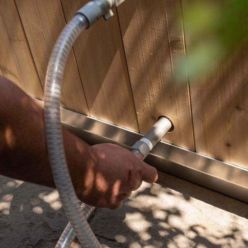 A man installing the Leisurecraft Canadian Timber Polar Cold Plunge Tub, showing how easily is done.