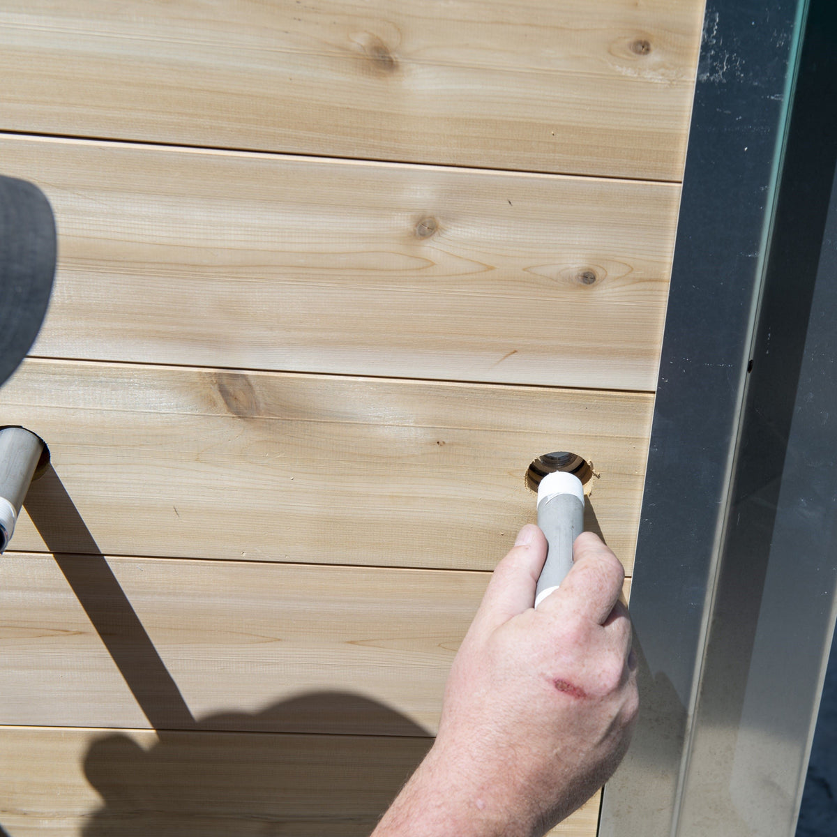 A man installing the Leisurecraft Canadian Timber Polar Cold Plunge Tub, showing how easily is done.