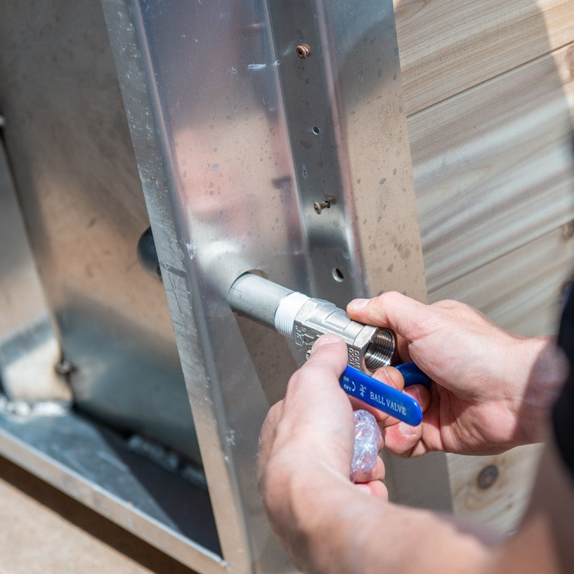 A man installing the Leisurecraft Canadian Timber Polar Cold Plunge Tub, showing how easily is done.