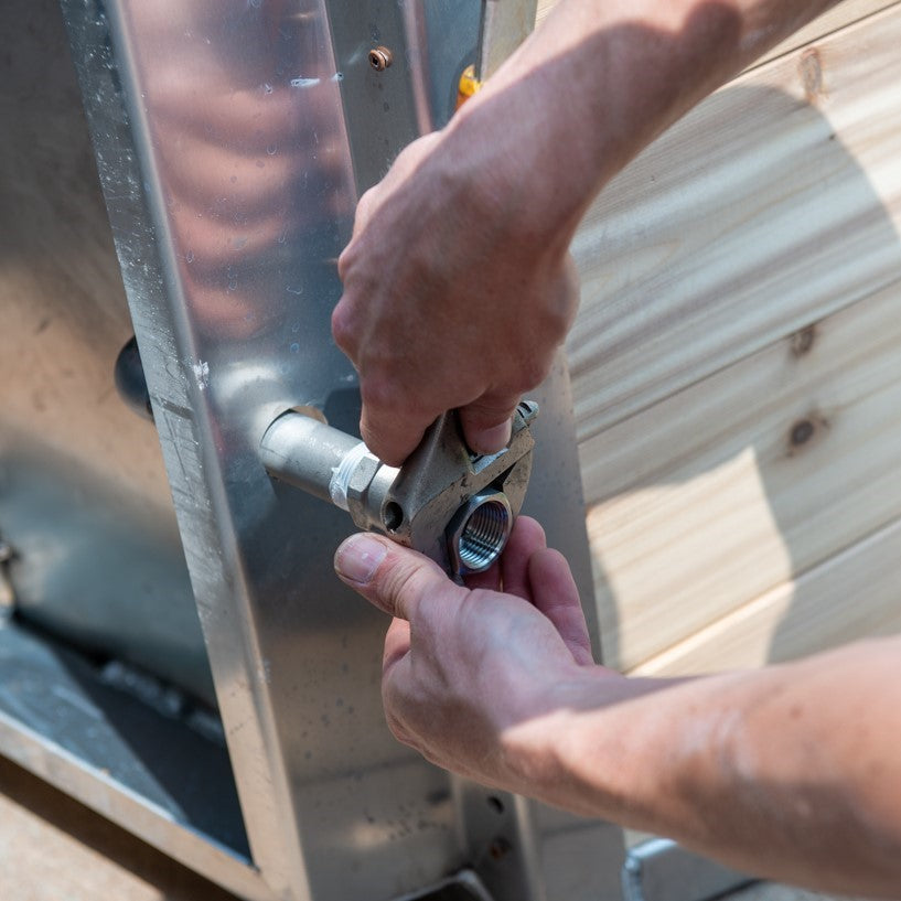 A man installing the Leisurecraft Canadian Timber Polar Cold Plunge Tub, showing how easily is done.