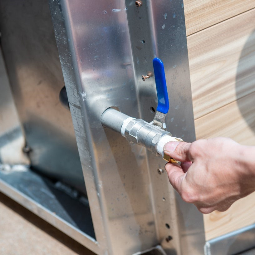 A man installing the Leisurecraft Canadian Timber Polar Cold Plunge Tub, showing how easily is done.