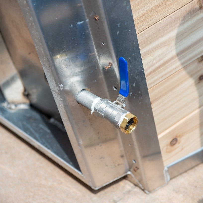 A man installing the Leisurecraft Canadian Timber Polar Cold Plunge Tub, showing how easily is done.