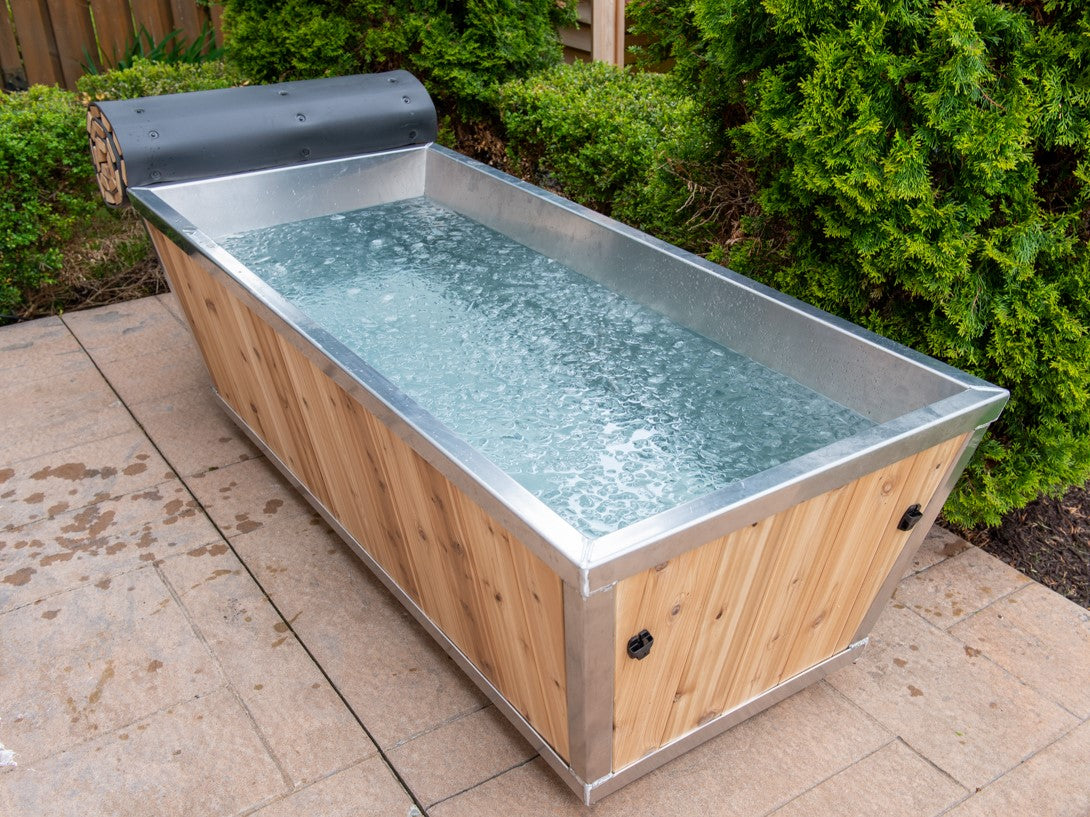 Side view of Leisurecraft Canadian Timber Polar Cold Plunge Tub filled with iced water, ready to be used. 