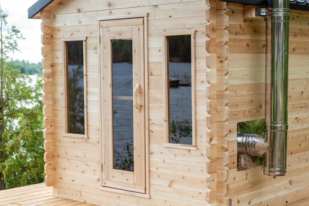 Close-up view of the entrance of Georgian Cabin Outdoor Sauna, showing its elegant door and windows. 