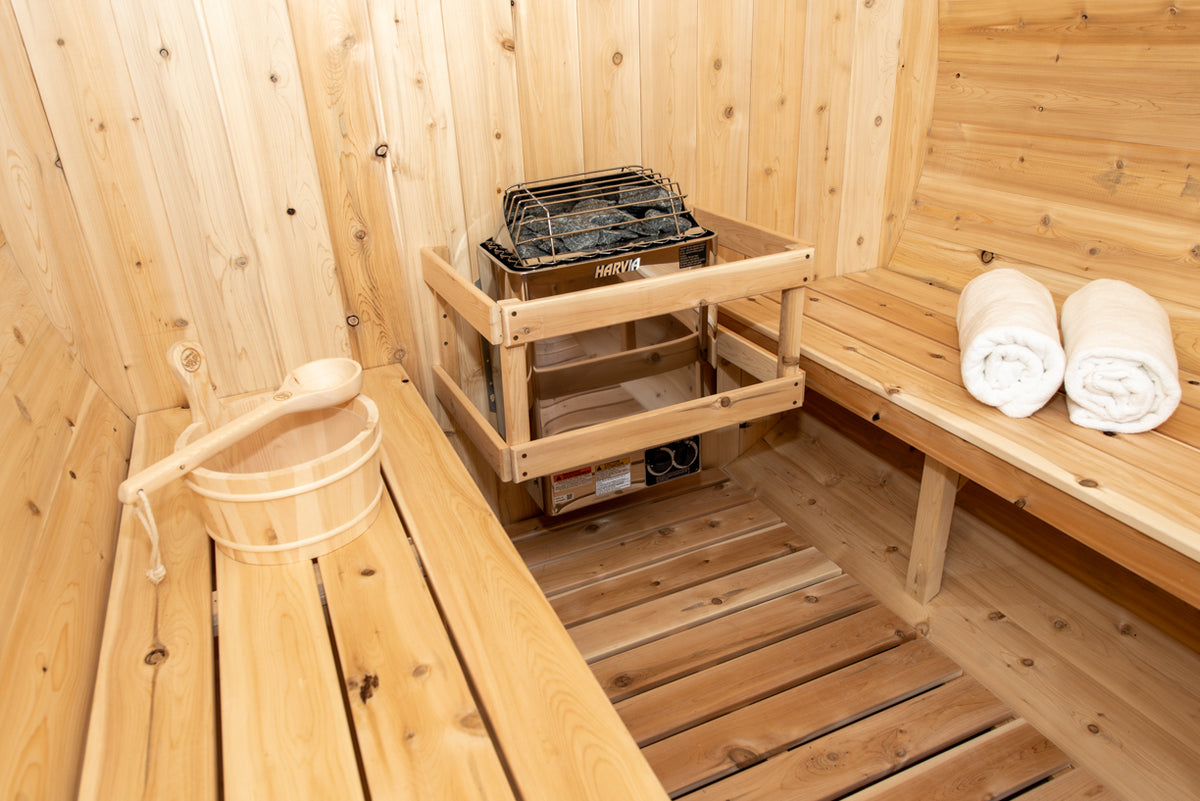 Close-up view of the heater of Leisurecraft Canadian Timber Harmony Barrel Sauna.