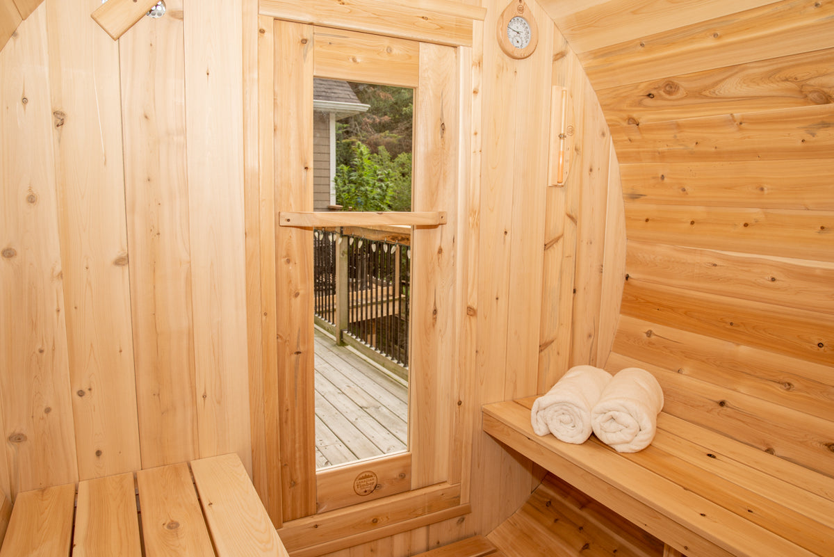 Close-up view of tempered glass door of Leisurecraft Canadian Timber Harmony Barrel Sauna.