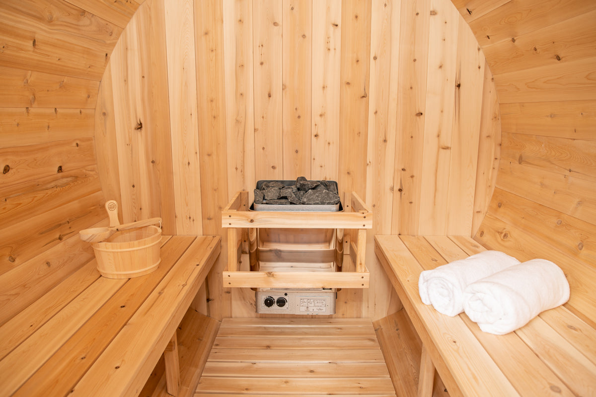 Close-up view of the heater of Leisurecraft Canadian Timber Harmony Barrel Sauna.