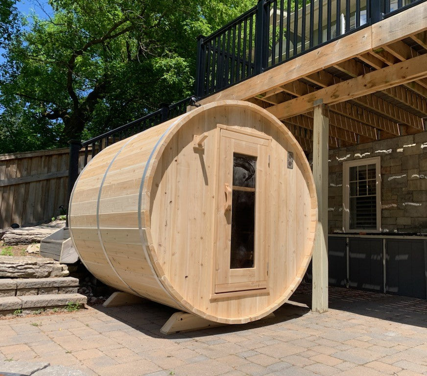 Leisurecraft Canadian Timber Harmony Barrel Sauna in an outdoor setting on a sunny day.