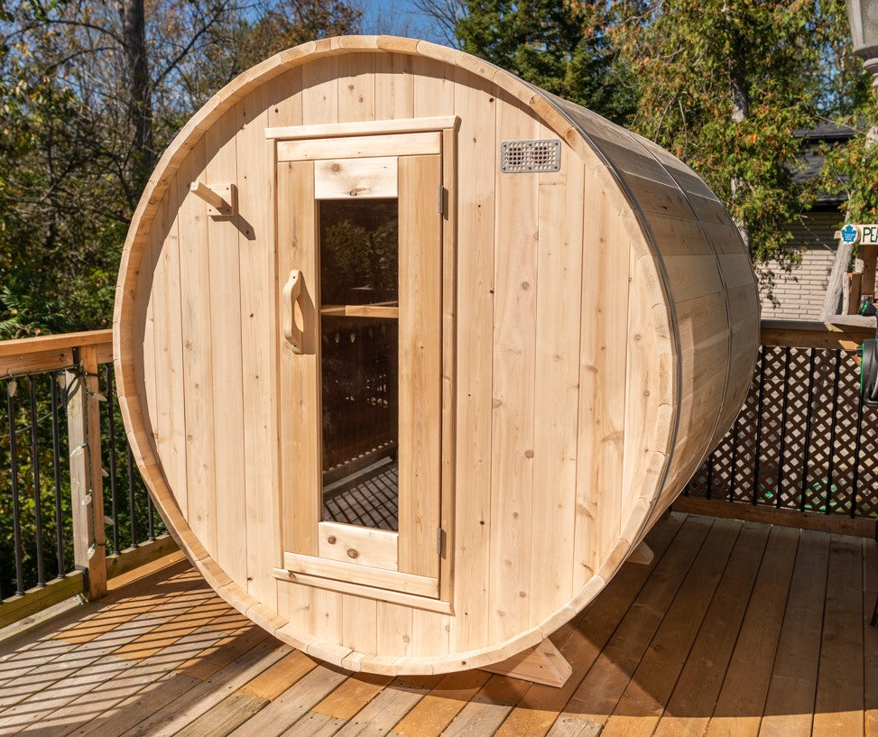 Side view of Leisurecraft Canadian Timber Harmony Barrel Sauna in an outdoor setting on a sunny day.