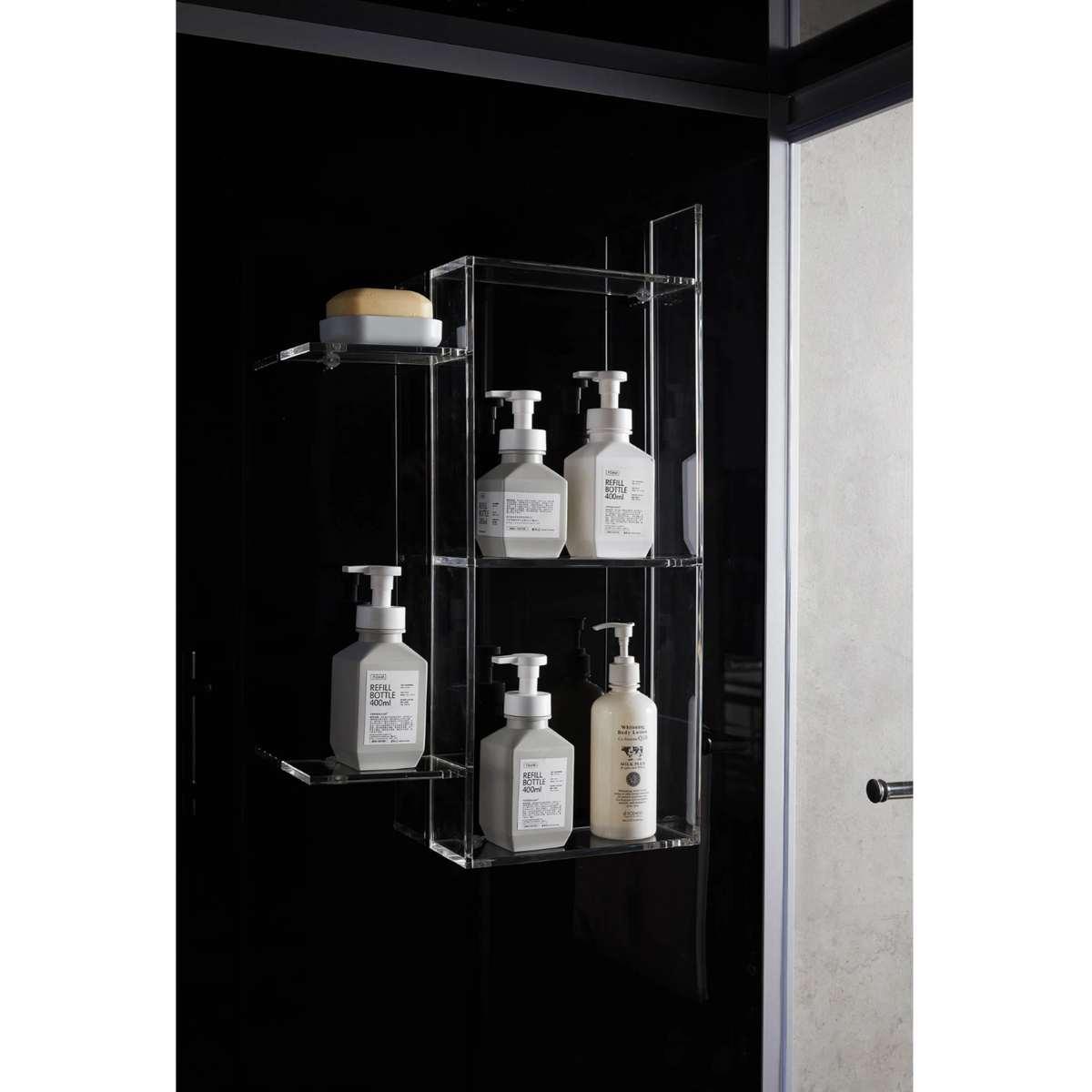 Close-up view of shampoo racks of Maya Bath Platinum Catania Steam Shower black version.