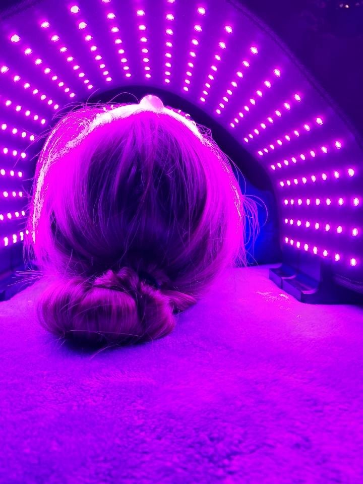 User undergoing purple light therapy with ORB Facial Light &amp; Therapy Wrap, for enhanced skincare treatment.