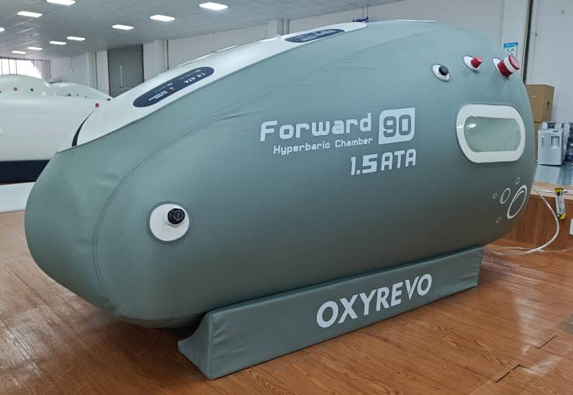 Left diagonal view of an OxyRevo Forward 90 1.4 ATA Hyperbaric Chamber in a production setting.