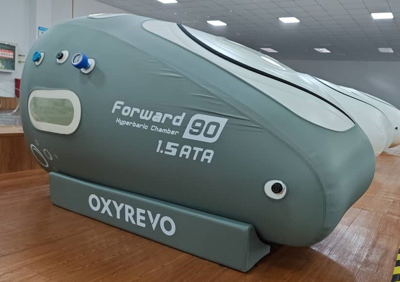 Right diagonal view of an OxyRevo Forward 90 1.4 ATA Hyperbaric Chamber in a production setting.