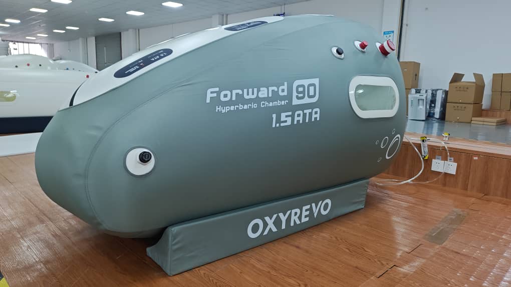 Left diagonal view of an OxyRevo Forward 90 1.5 ATA Hyperbaric Chamber in a production setting.