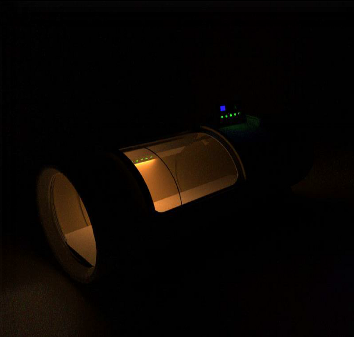 OxyRevo Quest 36 1.5 ATA Hyperbaric Chamber in a dark setting featuring its lights.