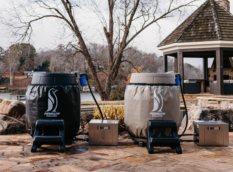 Outdoor setting featuring two Penguin Chillers insulated barrel wraps with chiller units.