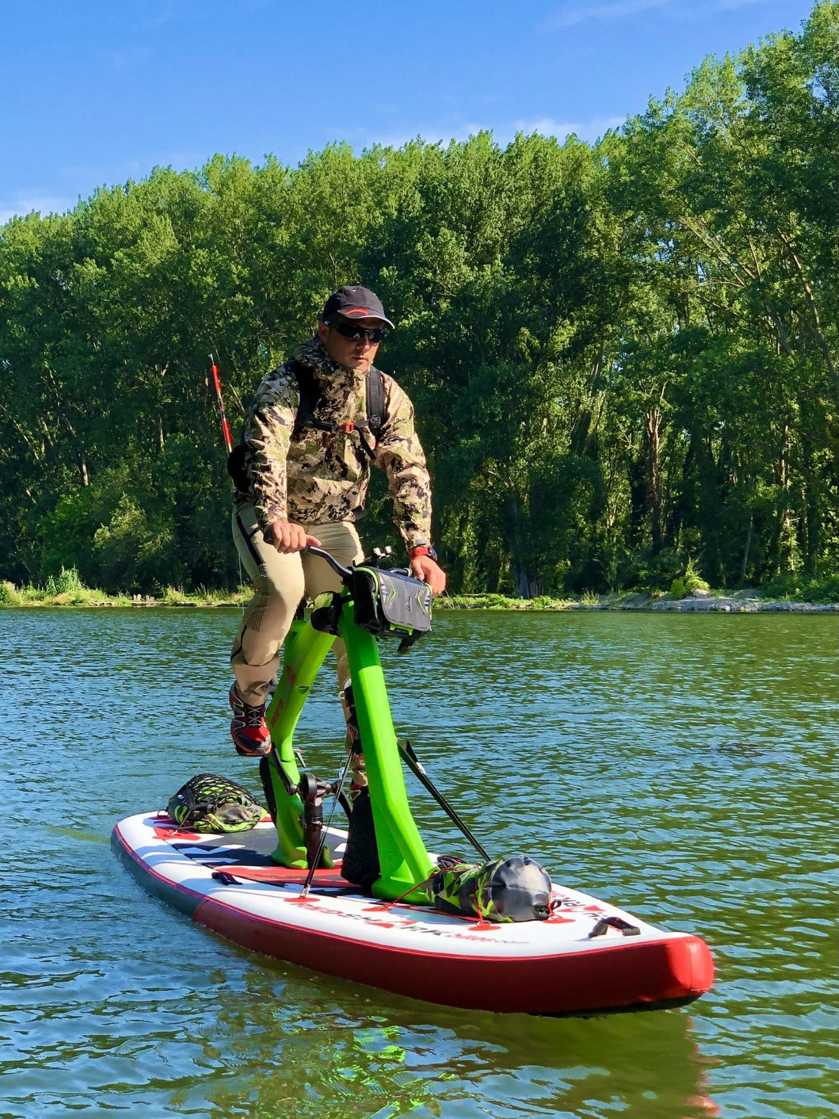 Red Shark Adventure Bike Surf on a clear lake with natural woodland backdrop.