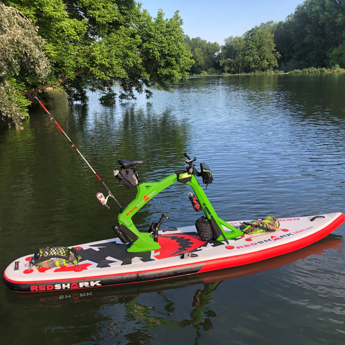 Red Shark Adventure Bike Surf on calm lake waters with fishing rod attached.