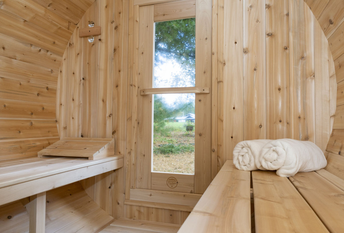 Close-up view of the tempered glass door / window of Leisurecraft Canadian Timber Outdoor Barrel Sauna.