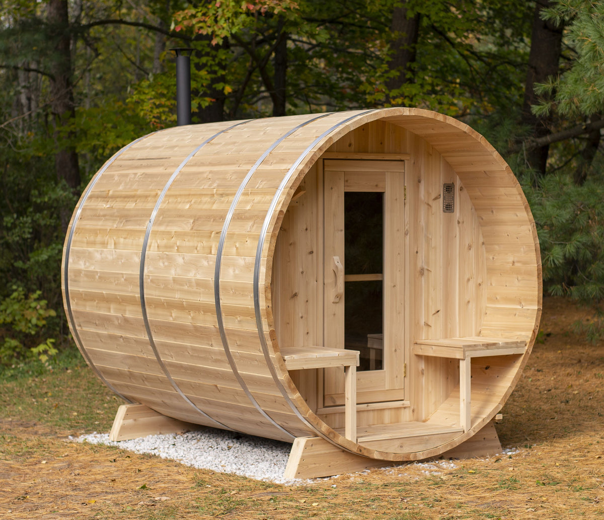 Main view of Leisurecraft Canadian Timber Outdoor Barrel Sauna in an outdoor setting surrounded by forest nature.