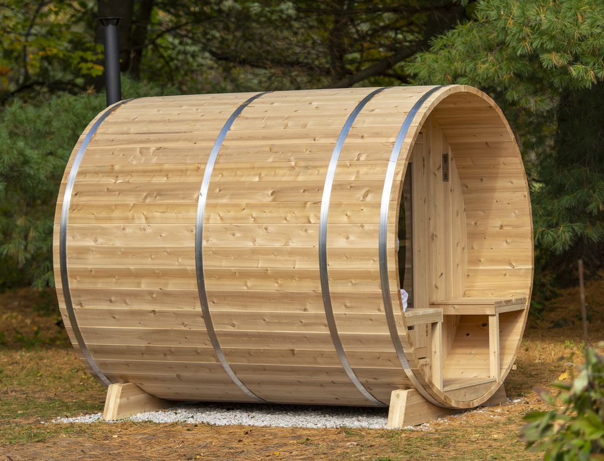 Side view of Leisurecraft Canadian Timber Outdoor Barrel Sauna in an outdoor setting surrounded by nature.