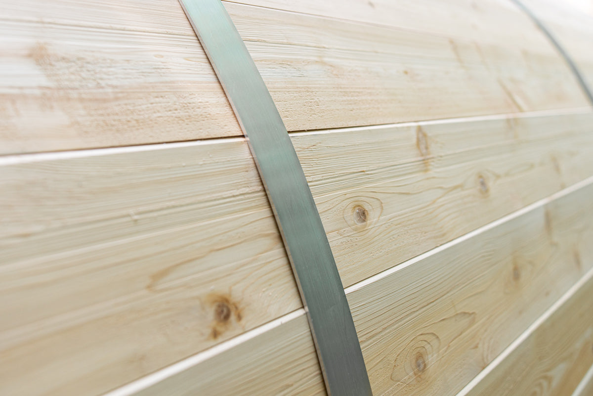 Close-up view of the aluminum bands of a Leisurecraft Canadian Timber Tranquility Outdoor Barrel Sauna.