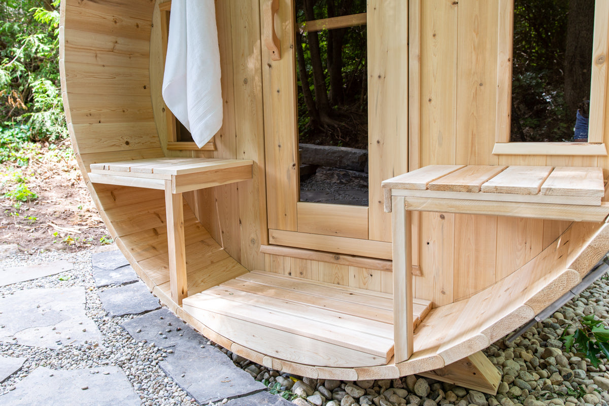 Close-up view of the canopy porch benches of Leisurecraft Canadian Timber Tranquility Outdoor Barrel Sauna.