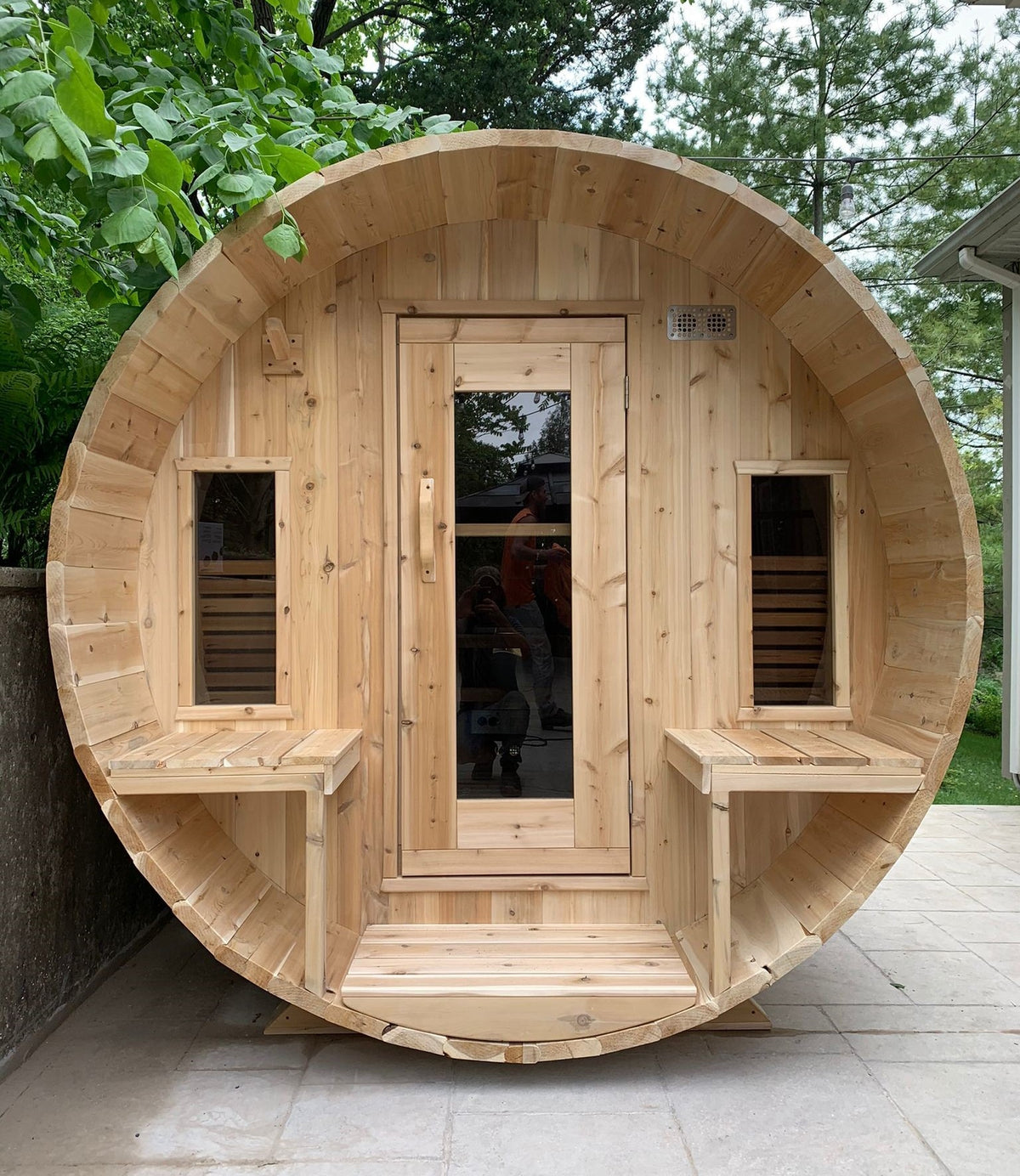 Front view of Leisurecraft Canadian Timber Tranquility Outdoor Barrel Sauna in an outdoor setting surrounded by nature.