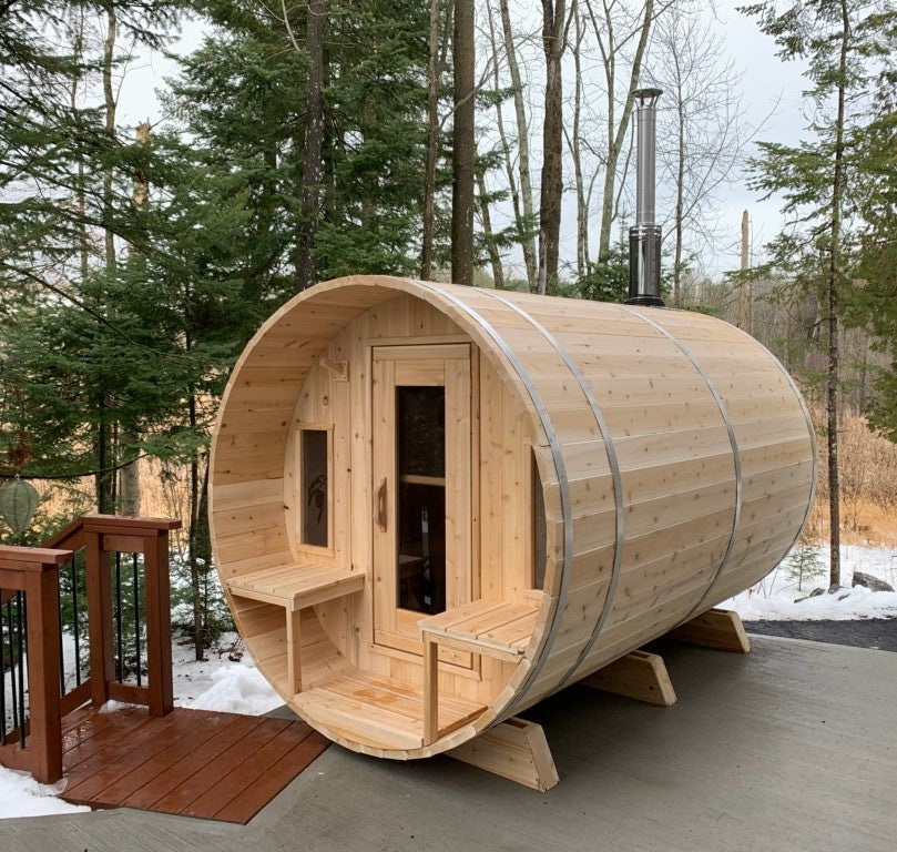 Leisurecraft Canadian Timber Tranquility Outdoor Barrel Sauna installed in a garden during a winter day.