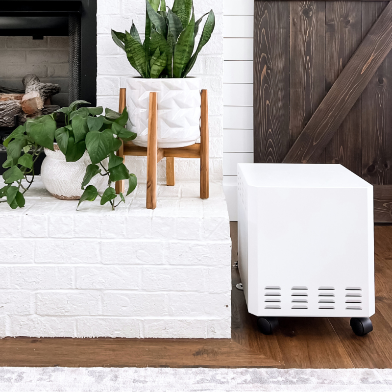 EnviroKlenz Air System positioned in a cozy living room corner, blending seamlessly with the home environment.