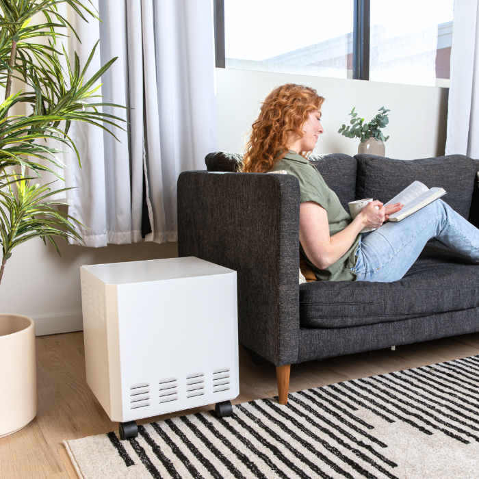 EnviroKlenz Air System positioned in a cozy living room corner, blending seamlessly with the home environment.