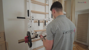 A man using a BenchK 231 Wall Bars & Gymnastic Ladders.