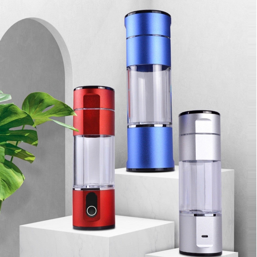 Assortment of Prime Biohacking Hydrogen Water Bottles in red, blue, and silver colors displayed on a modern minimalist stand.